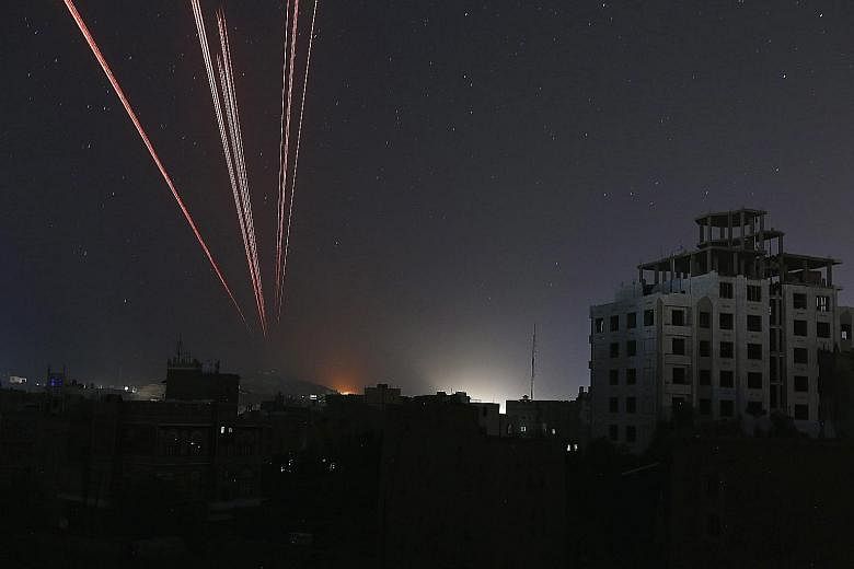 The sky over a Sanaa neighbourhood is illuminated by anti-aircraft fire as the Saudi-led coalition intensified airstrikes on Houthi positions in the capital of Yemen yesterday. The Saudi-led forces are trying to restore exiled President Abedrabbo Man