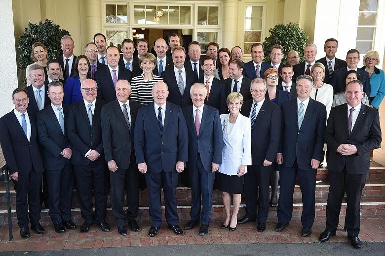 New Australian Prime Minister Malcolm Turnbull (front, sixth from left) after the swearing-in ceremony of the new Turnbull Cabinet at Government House in Canberra yesterday. Mr Turnbull yesterday insisted the ministers were appointed on merit and he 