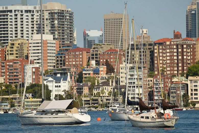 Apartment buildings lining the harbourfront in Sydney. Australian property prices, particularly in Sydney and Melbourne, have soared in recent years. But demand is now sliding. Auction clearance rates in Sydney dropped to about 73 per cent for the we