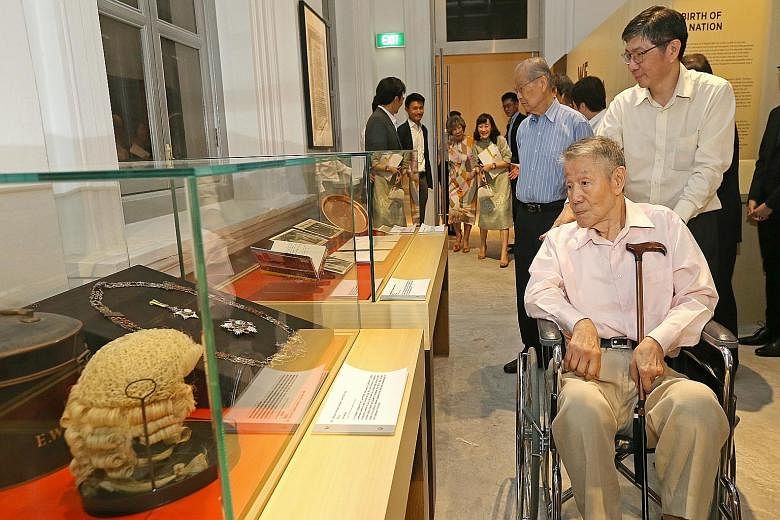 Former labour minister Jek Yeun Thong (right, seated), his son Jek Kian Yee, and former education minister Ong Pang Boon (centre, in blue shirt) at the preview of the National Museum's new exhibition called We Built A Nation, which chronicles the con