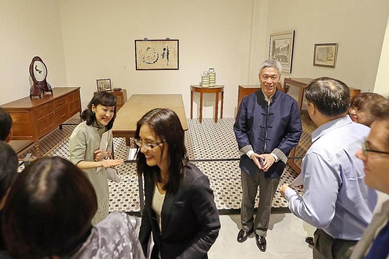 Mr Lee Hsien Yang (second from right), with his wife (second from left) Lee Suet Fern, explaining to guests the uses and significance of furniture and exhibits from Mr Lee Kuan Yew's house at the preview of the exhibition. Guests at the preview of th