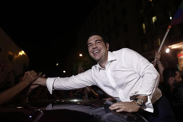 Greek Prime Minister Alexis Tsipras being congratulated on Sunday on winning the country's latest election. The news had little impact on Asian markets as investors now have other concerns on their minds, such as an economic slowdown in China and whe