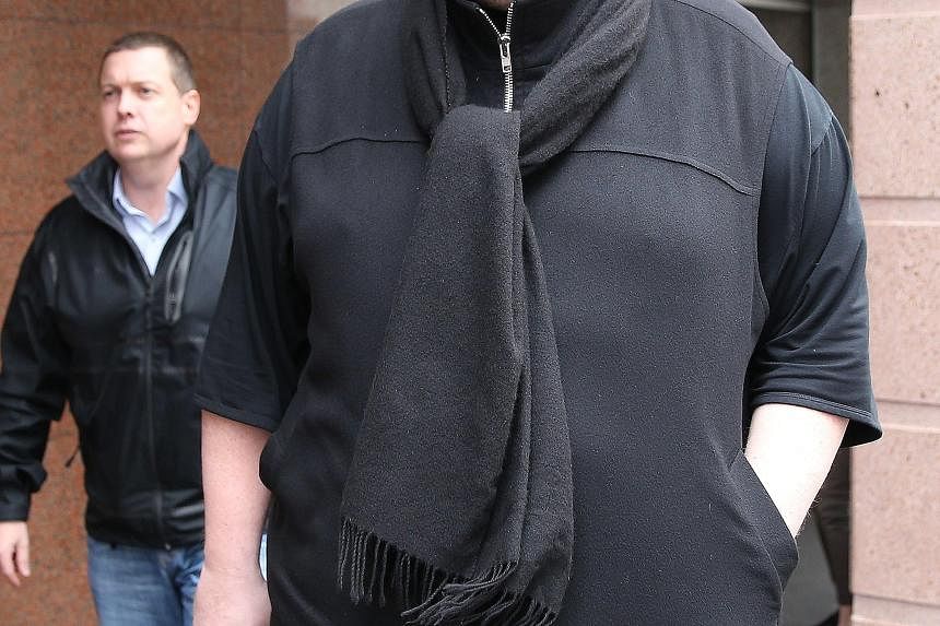 Megaupload's Kim Dotcom leaving court yesterday as he fights a US bid to extradite him from New Zealand.