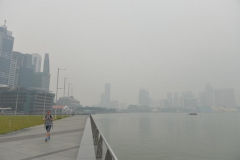 The Singapore skyline obscured by haze in the Marina Bay area at around 2pm yesterday. The 24-hour PSI stood at 85-103 at 5pm yesterday, in the moderate to unhealthy ranges.