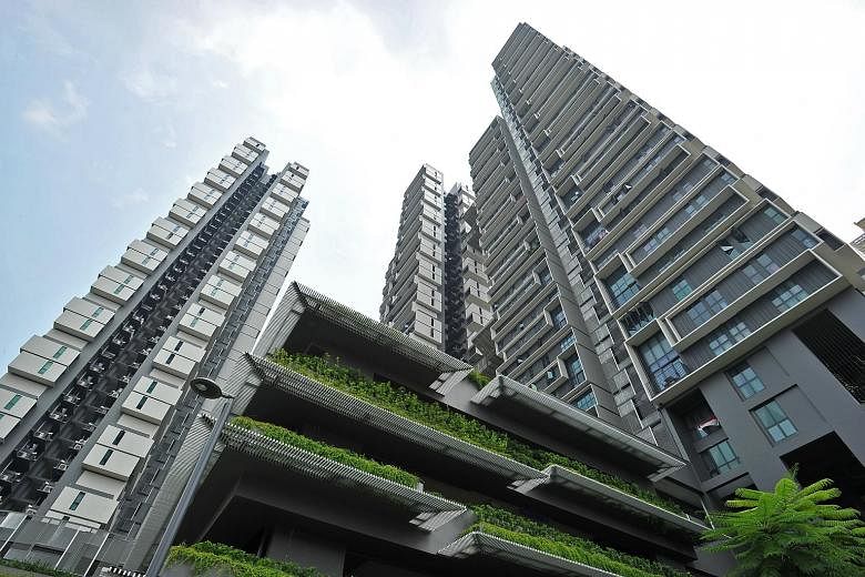 Mr Cheah Tse Boon (above) with his wife, Ms Jean Foo, and their son Elias, in their paired unit which consists of five-room loft unit with studio apartment. The development (right) has green roof terraces and terraced planting which dangles over its 