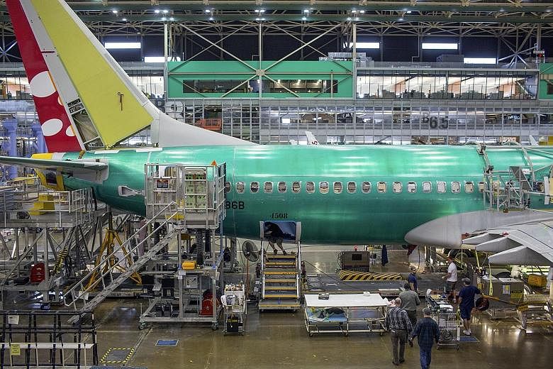 Workers assembling a Boeing 737 aeroplane at the company's factory in Renton, Washington. Boeing has signed a cooperation document to build an aircraft completion centre in China, Xinhua reported.