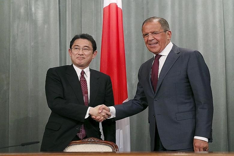 Russian Foreign Minister Sergei Lavrov (at right) and his Japanese counterpart Fumio Kishida after their joint news conference in Moscow.