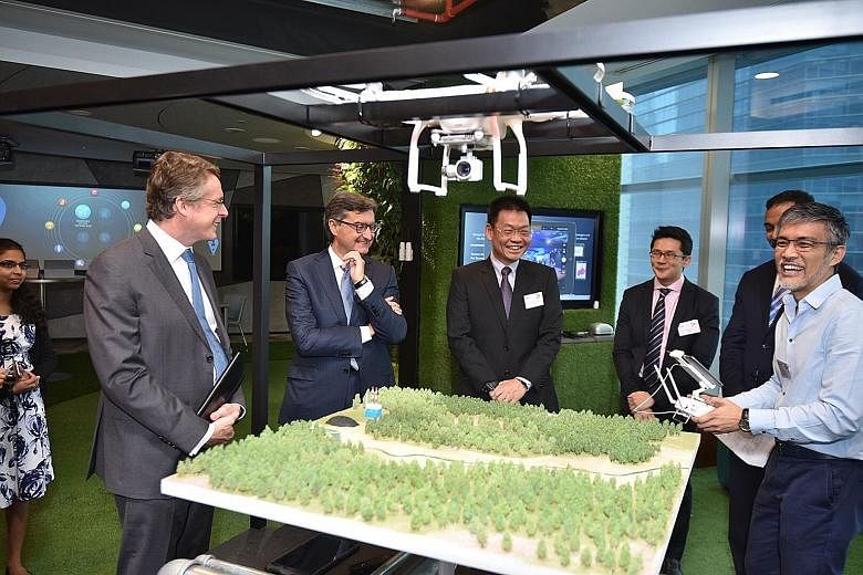 Accenture's Mr Gianfranco Casati (second from left) and EDB managing director Yeoh Keat Chuan (third from left) hope to see the centre help firms create new innovations with IoT technologies.