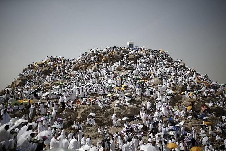 Muslim pilgrims at Mount Mercy on the plains of Arafat, where millions gathered during the annual haj pilgrimage, outside the holy city of Mecca yesterday. Many were praying for peace in the Middle East countries ravaged by war and chaos, as the annu