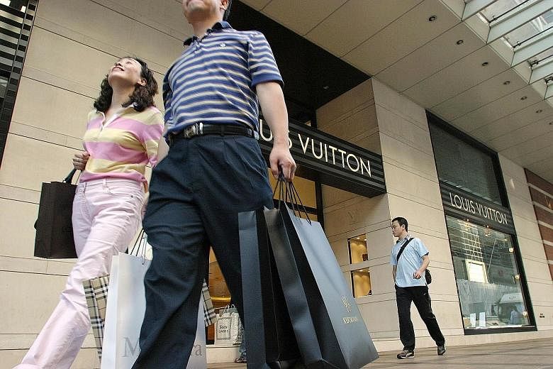 Chinese tourists outside luxury goods stores in Hong Kong. Luxury sales have been falling in Hong Kong because many Chinese spenders are now heading to more "fashionable" destinations such as Japan, South Korea and Taiwan, says HSBC Global's co-head 