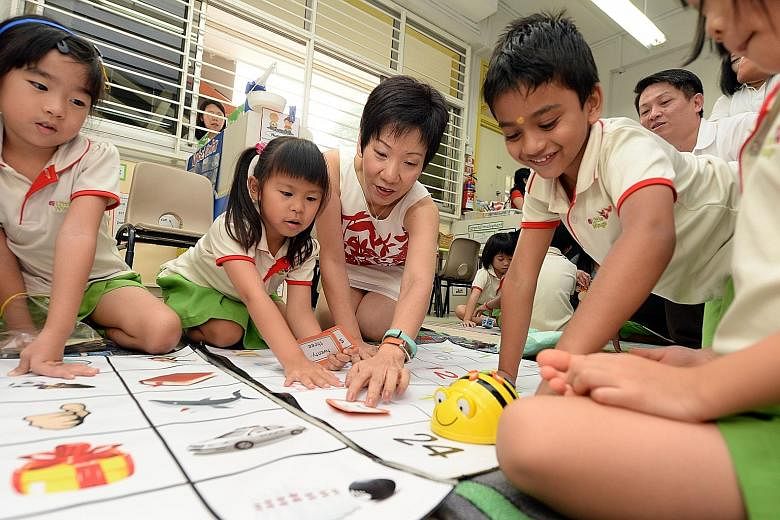Ms Grace Fu, MP for Yuhua and Minister in the Prime Minister's Office, playing with the children at the PAP Community Foundation Sparkletots pre-school in Yuhua using the BeeBot teaching tool.