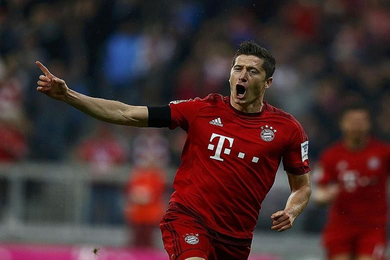Lewandowski (left) scoring his first goal. His five goals against Wolfsburg came from nine shots and 30 touches.