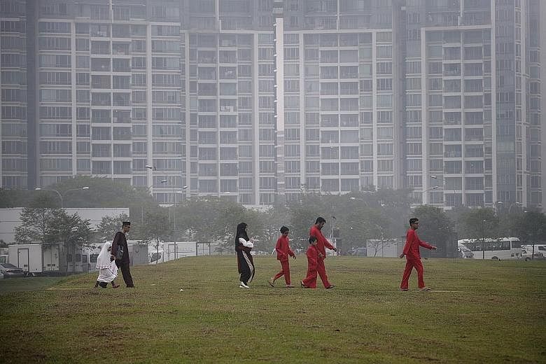MALAYSIA: People having a dip at Stulang in Johor Baru during the holiday yesterday despite the haze which partly obscured the Berjaya Waterfront Hotel in the background. INDONESIA: (Above) Soldiers surveying burnt peat land during President Joko Wid