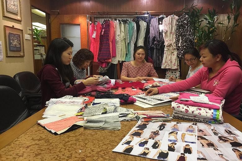 Ms Janice Tan (centre), general manager of textile and garments trader Tantex, at a meeting with her staff. She attributes the company's success to the good partnership and alliances that it forms with manufacturing plants in South-east Asia.
