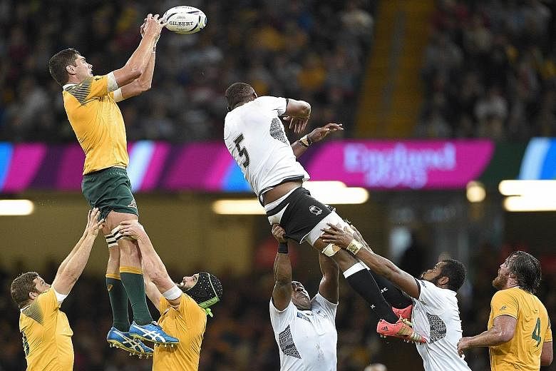 Australia's Rob Simmons (left) catching the ball in a line-out against Fiji's Leone Nakarawa (No. 5). Wallabies coach Michael Cheika has deployed a rolling maul off attacking line-outs to good effect.