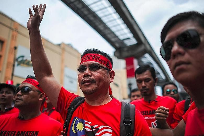 Mr Jamal Yunos (centre), leader of the "Himpunan Maruah Melayu" (Malay Dignity Uprising) rally, warned of "another commotion" in Petaling Street if demands by the red-shirt protesters are not met.