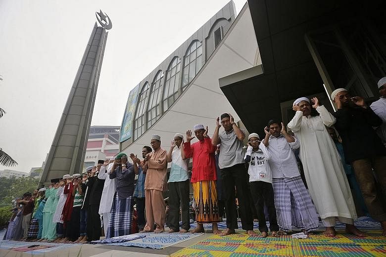Worshippers at Al-Mawaddah Mosque praying on Hari Raya Haji yesterday. At the mosque in Sengkang, 224 lambs were sacrificed and a portion of the meat was given to 114 needy families.