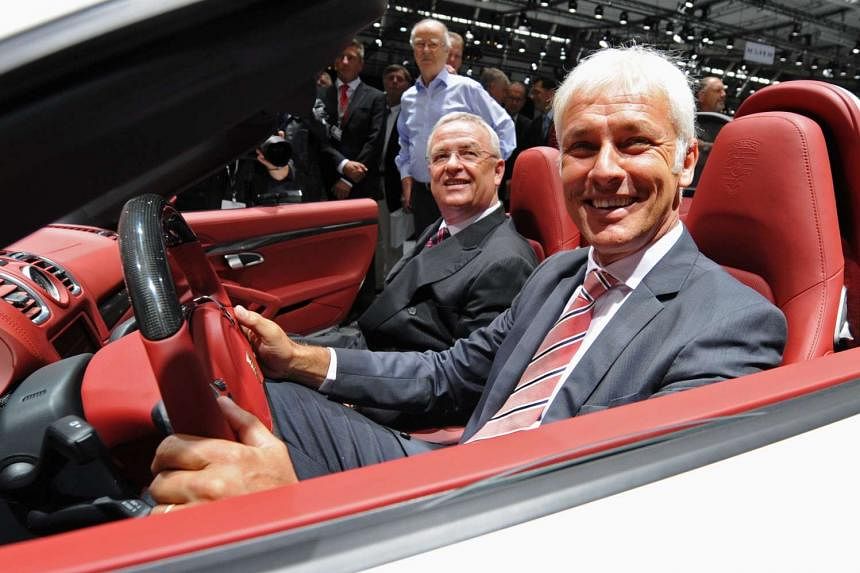 Porsche unit chief Matthias Mueller in driver's seat) has been named as a possible successor to discredited Volkswagen CEO Martin Winterkorn (seated beside him).