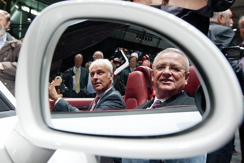 Porsche chief Matthias Mueller (left) - seen in a 2012 photo with Mr Martin Winterkorn in a Porsche Boxster S sports car - has been named by Volkswagen's board to replace Mr Winterkorn as CEO. The latter was forced to resign.