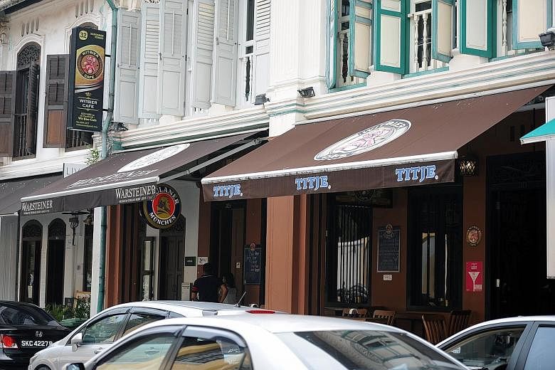 Project Lifestyle, which runs Witbier Cafe (left), was fined $35,000 yesterday for flouting a ban on bars and pubs in the Kampong Glam conservation area. It is the first such case to be prosecuted in court. The firm had ignored repeated enforcement n