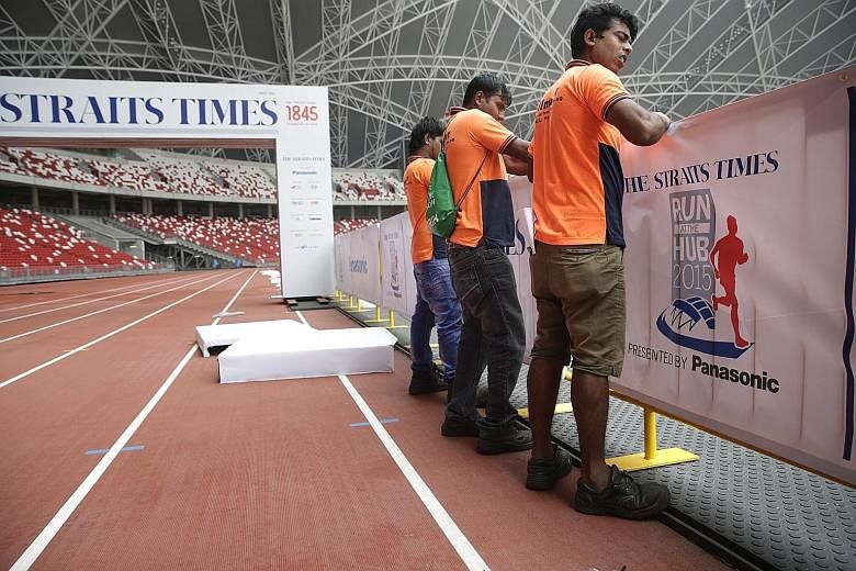 The Straits Times Run At The Hub race village being set up inside the National Stadium. A host of activities awaits runners afterwards.