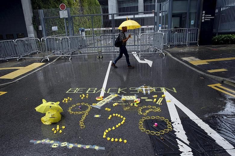 A sign with the numbers "928" left by pro-democracy activists on the road outside government headquarters in Hong Kong. Next Monday is the first anniversary of the Occupy Central civil disobedience movement, which started on Sept 28 last year.