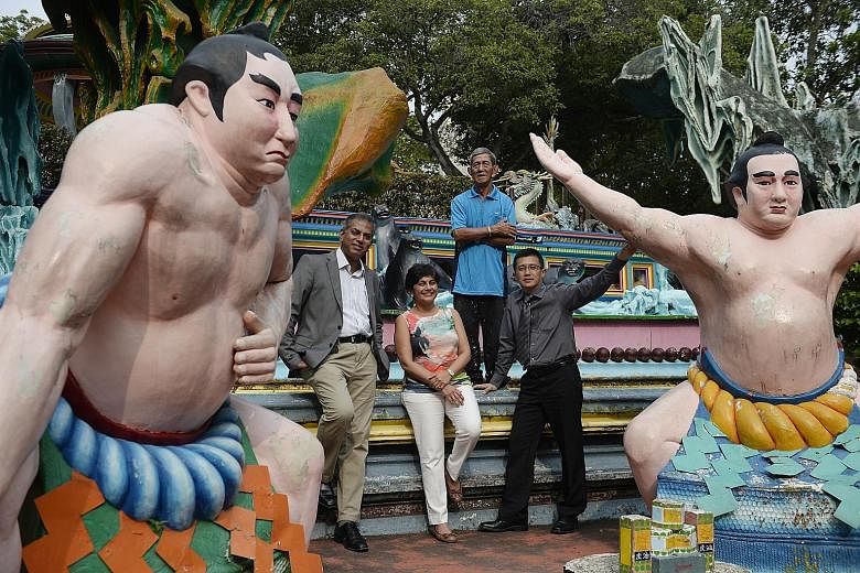 Tour operator Journeys' chairman of the board of directors Jeya Ayadurai (left) at Haw Par Villa with colleagues Savita Kasyhap and Chan Ying Loone, and park artisan Teo Veoh Seng (rear). The park's quirky statues and gruesome depiction of the underw