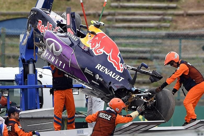 The Red Bull of Daniil Kvyat being hoisted onto a truck after his crash in qualifying at Suzuka. Lewis Hamilton will hope for a repeat of last year, when he beat pole-sitter and Mercedes team-mate Nico Rosberg to win the race.