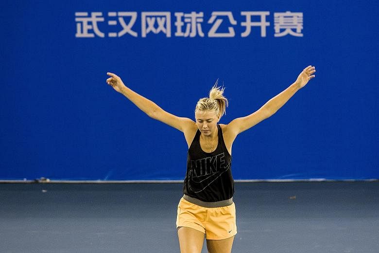 Maria Sharapova is using the Wuhan Open to get back into rhythm after a short lay-off because of injury. She says she is not rushing things but is eyeing gold at the Rio Olympics.