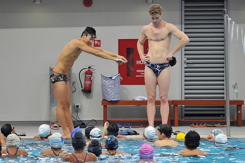 Quah Zheng Wen (left) and Kevin Cordes sharing their insights and techniques at a clinic conducted for swimming clubs and Singapore Swimming Association affiliates at the OCBC Aquatic Centre. Quah says taking part in big meets has exposed him to the 