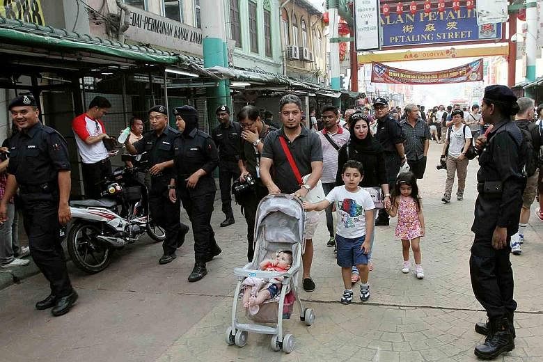 It was business as usual in Petaling Street yesterday, with a strong police presence adding to the congestion.