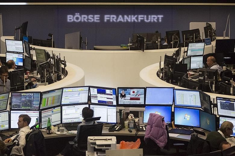 Financial traders monitoring data on computer screens at the Frankfurt Stock Exchange in Frankfurt, Germany, on Friday. Since Volkwagen's deception came to light, its stocks have plunged.