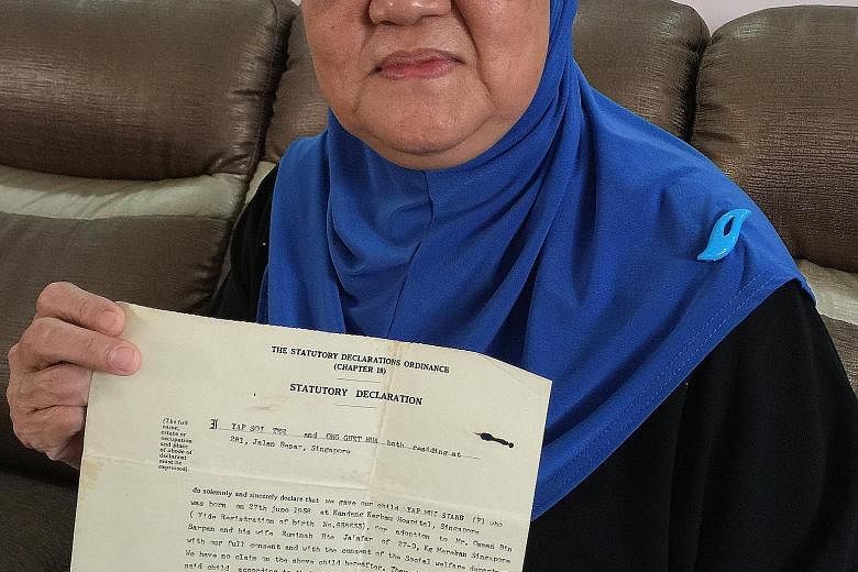 Madam Amedah Osman (far right) with her adoptive mother, Madam Ruminah Jaafar. Above, the birth certificate which states Jalan Besar as the address of her biological parents.