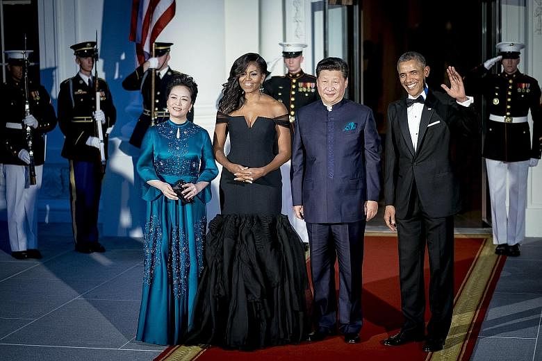 At a White House dinner held in honour of her husband, Ms Peng's (above left) teal-blue gown, matching the colour of Mr Xi's pocket square, features detailed embroidery. Lest you call her too conservative, she shows a bit of skin with cropped sleeves and 