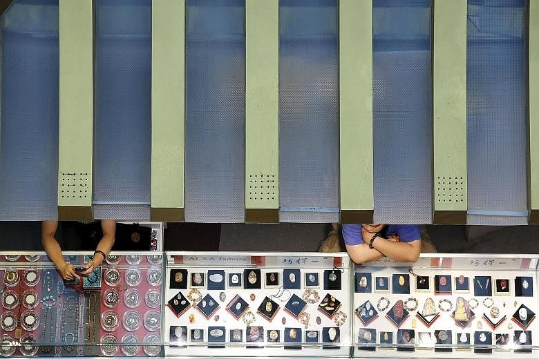 Sales staff in a shop in Beijing twiddling their thumbs as they wait for customers. The US Federal Reserve sees China's slowdown, with its adverse impact on global demand, as good enough reason to put a rate-hike on hold.