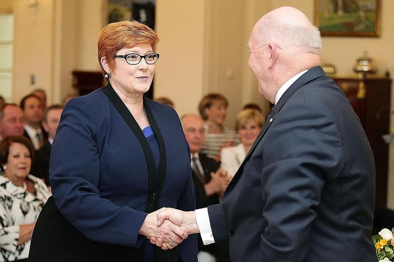 Ms Marise Payne being congratulated by Australian Governor-General Peter Cosgrove after she was sworn in as the country's first female defence minister in Canberra last Monday. At her first press conference as minister, she asked to be judged "on my 