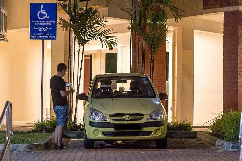 A man leaving his car in a reserved space at a block in Tampines Street 45. A committee has been formed to review the parking system for the disabled.