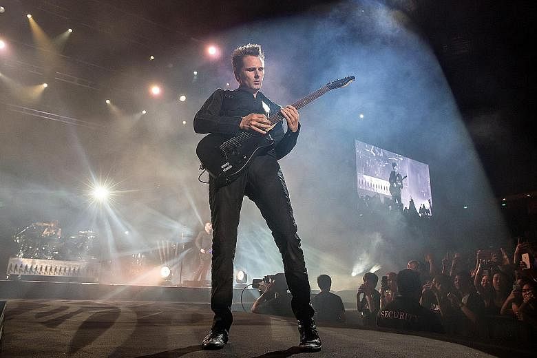 Muse frontman and guitarist Matt Bellamy (above) performed impressive guitar solos at last Saturday's concert.