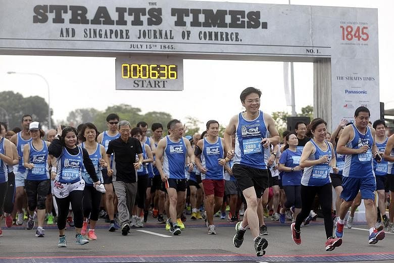 Minister for Culture, Community and Youth Lawrence Wong (foreground, third from right), the guest of honour at the event, participating in the 5km fun run with Singapore Press Holdings (SPH) chairman Lee Boon Yang (in black), Straits Times managing e