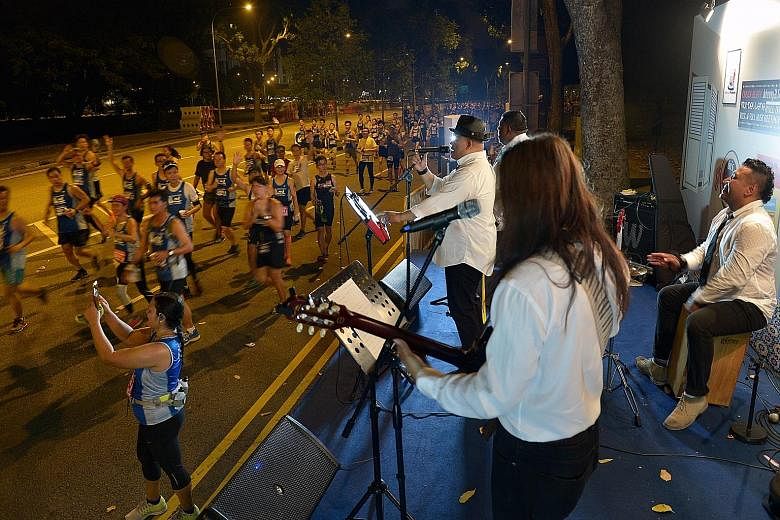 Participants in the 18.45km race being entertained by Shuk And Fren, who belted out 1960s hits from bands like The Beatles. The route took participants past iconic landmarks such as Marina Bay Sands and the Merlion.