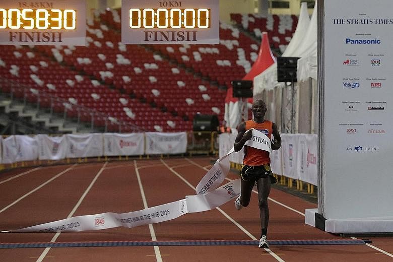 Kenyan David Kibet crossing the finish line for the men's 18.45km race at the National Stadium yesterday. This was the 27-year-old's first race in Singapore.
