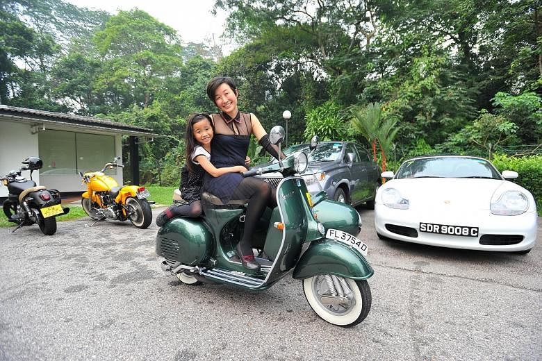 Ms Jobina Tan, 40, and her daughter Miriam, seven, at the start of the Distinguished Gentleman's Ride yesterday. The civil servant was among a handful of female riders who took part in the event, which is part of a global effort to raise money for pr