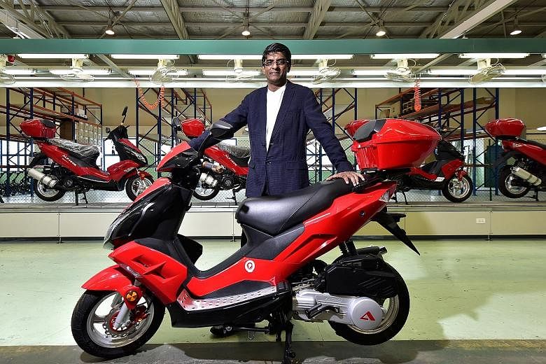 Alife Air Automobiles' president and CEO Devan Nair with the A bike, which comes in 125cc and 150cc variants and in four designs. The scooters are designed and assembled in Singapore. Behind Mr Nair is the assembly line in Bukit Batok.