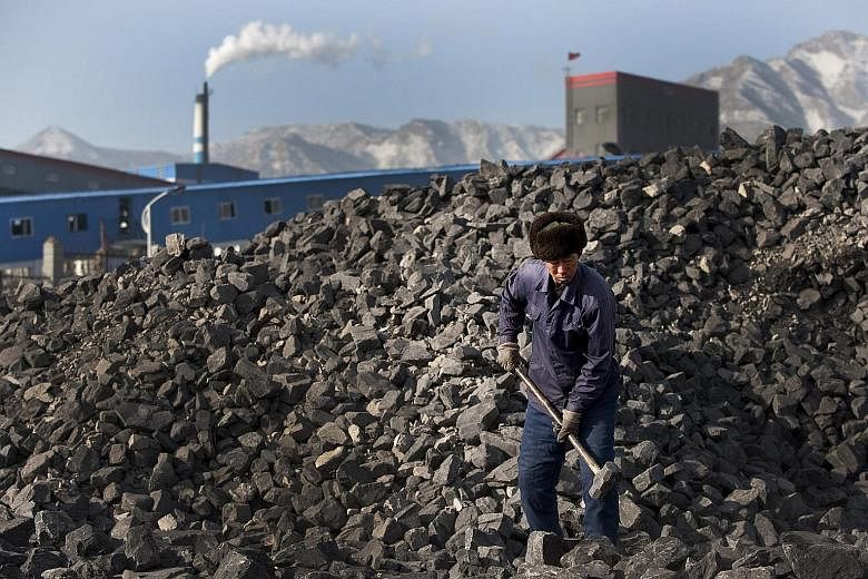 A coal worker in Shanxi province in China. Profits in coal mining plunged 64.9 per cent in the first eight months of this year from the same period last year, while oil and gas profits tumbled 67.3 per cent.