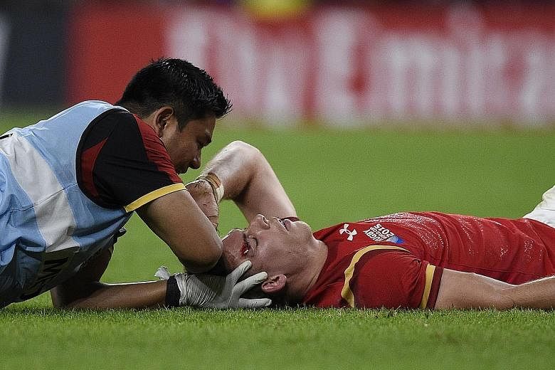 Wales' full-back Liam Williams receiving medical attention after he is kicked in the head by Tom Wood. The England flanker has apologised and says his action was not on purpose.