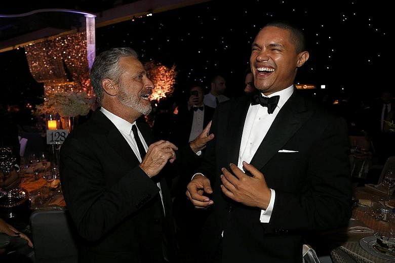 Comic Trevor Noah (left, with Jon Stewart) intends to broaden the horizons of the largely United States-centric The Daily Show that Stewart hosted for 16 years.