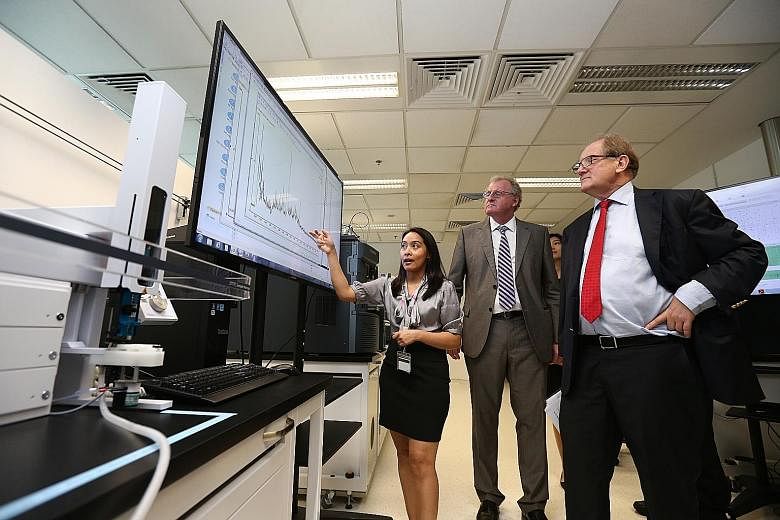 NTU President Bertil Andersson (right) and director of the Singapore Phenome Centre Bernhard Boehm (centre) with one of the centre's researchers at the $9 million research facility, which was launched yesterday.