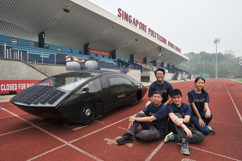 (Clockwise from bottom left) Team manager and senior lecturer Steven Chew with students Daniel Quick, 20; Lee Sunho, 21; and Cheong Yong Quan, 21, who are driving the Singapore Polytechnic team's black SunSPEC4, a 220kg carbon-fibre car lined with so