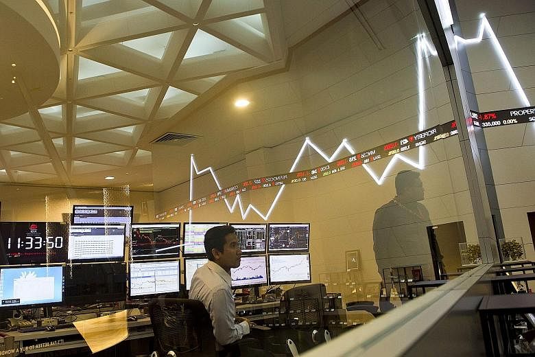 Employees monitoring share prices at the Jakarta Stock Exchange in Indonesia. Resources firms led by mining giant Glencore headed a deep sell-off in Asian markets yesterday, following painful losses across Europe and New York as fears about China's s