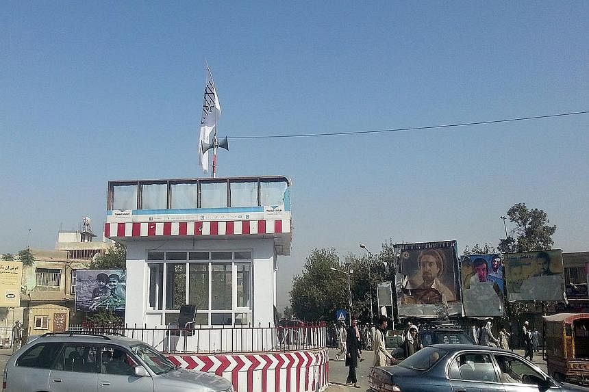 A Taleban flag flutters over the main traffic roundabout, a day after Taleban insurgents overran the northern city of Kunduz on Monday, in their biggest victory since being ousted from power in 2001. Afghan troops, backed by US air support, has mobil